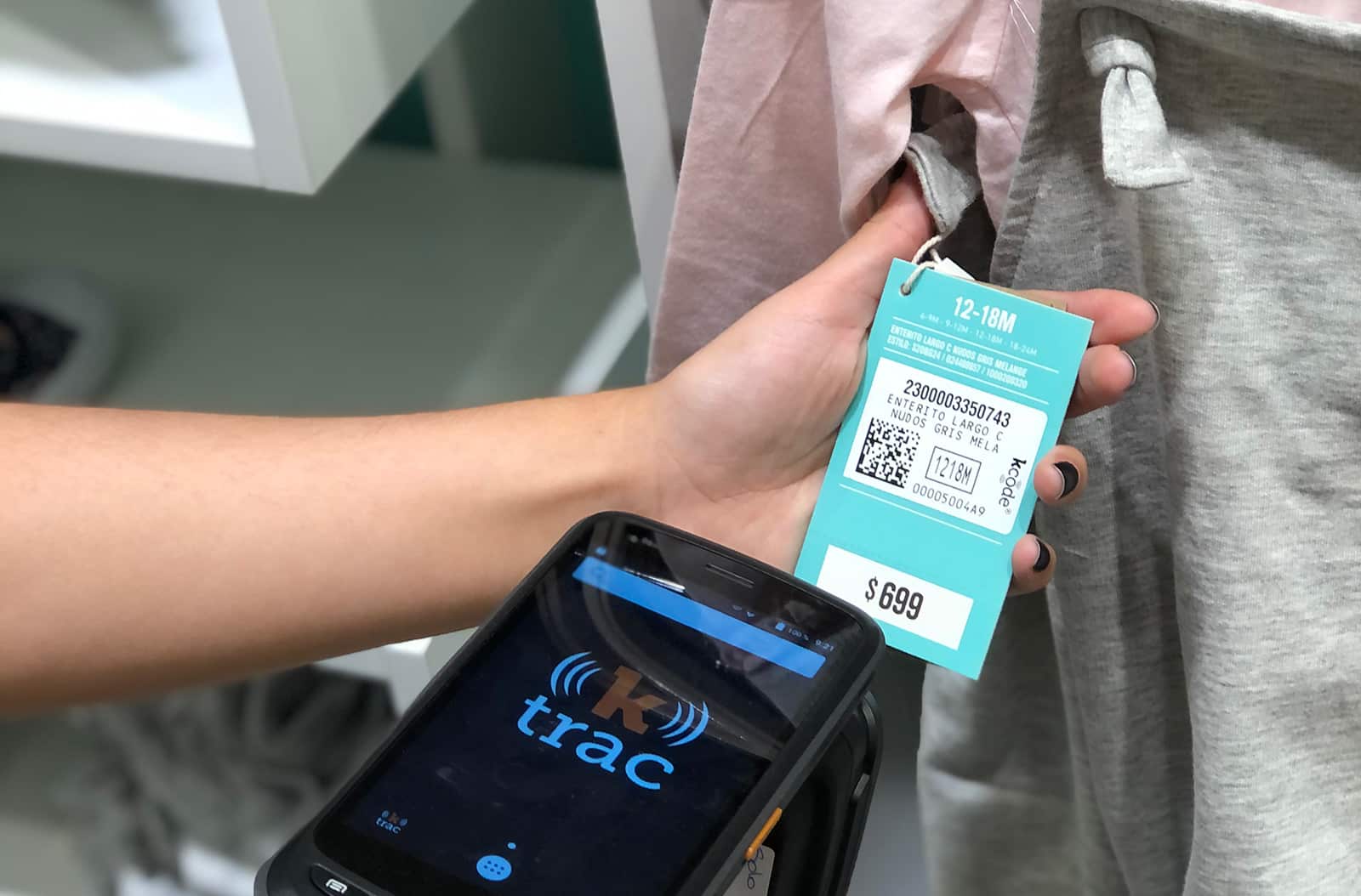 Clothing store employee scanning ktag with ktrac handheld scanner