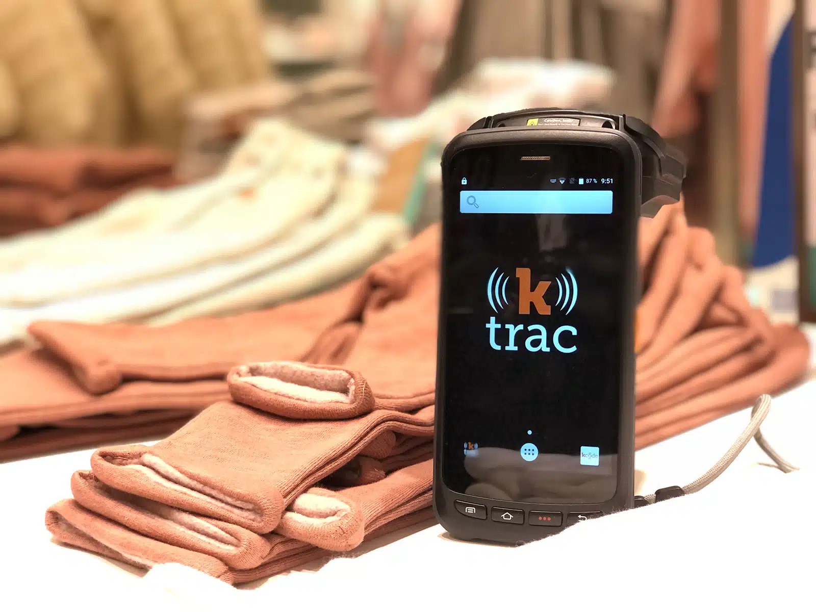 ktrac scanner sitting in front of folded clothing